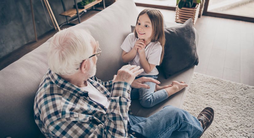 Old man telling a story to a enthralled young girl